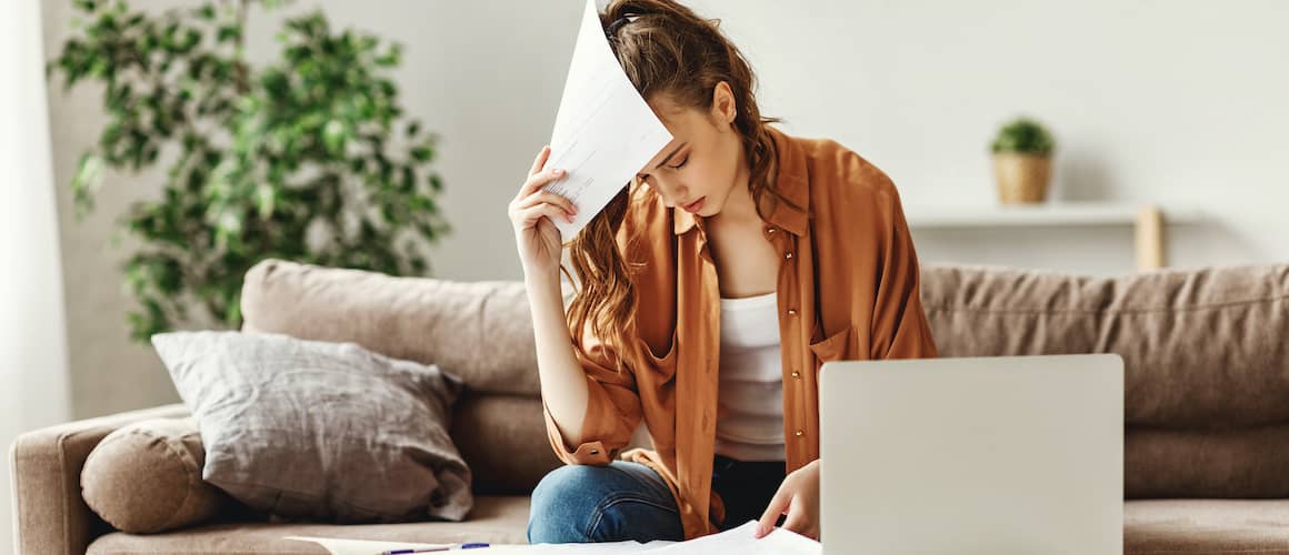 A woman managing bills or finances, possibly organizing payments or budgeting.