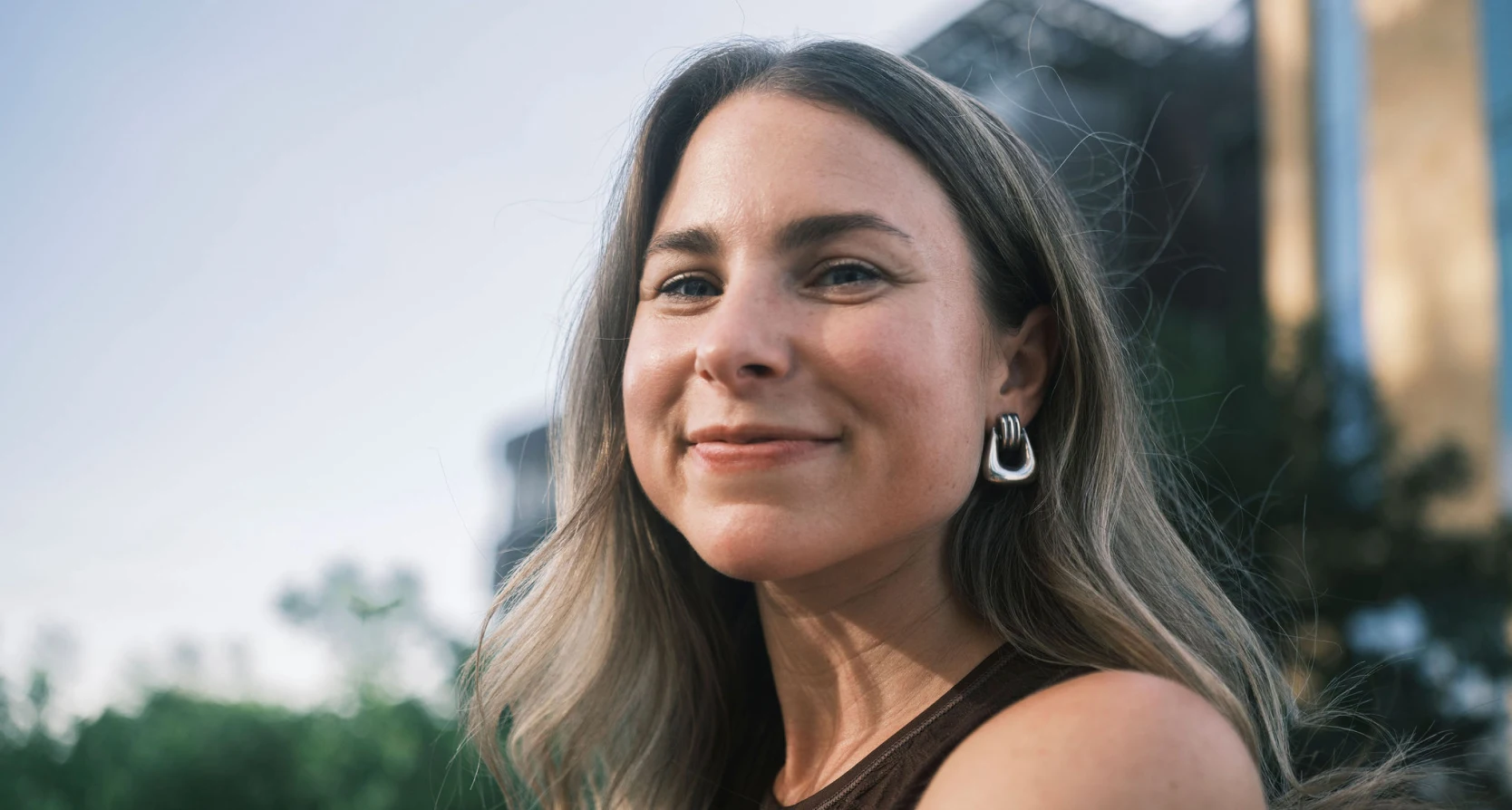 The experts at Rocket Mortgage help people like this white woman with long hair and a confident smile become homeowners.